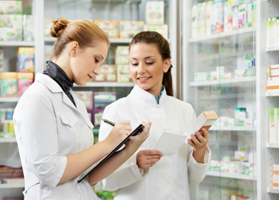 Pharmacist talking to her Pharmacist assistant